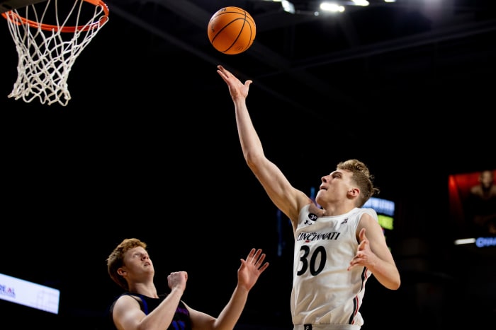 Cincinnati Bearcats forward Viktor Lakhin (30) hits a layup over Presbyterian Blue Hose forward Owen McCormack (15) in the second half of the NCAA men's basketball game on Thursday, Nov. 18, 2021, at Fifth Third Arena in Cincinnati. Cincinnati Bearcats defeated Presbyterian Blue Hose 79-45. Presbyterian Blue Hose At Cincinnati Bearcats 38